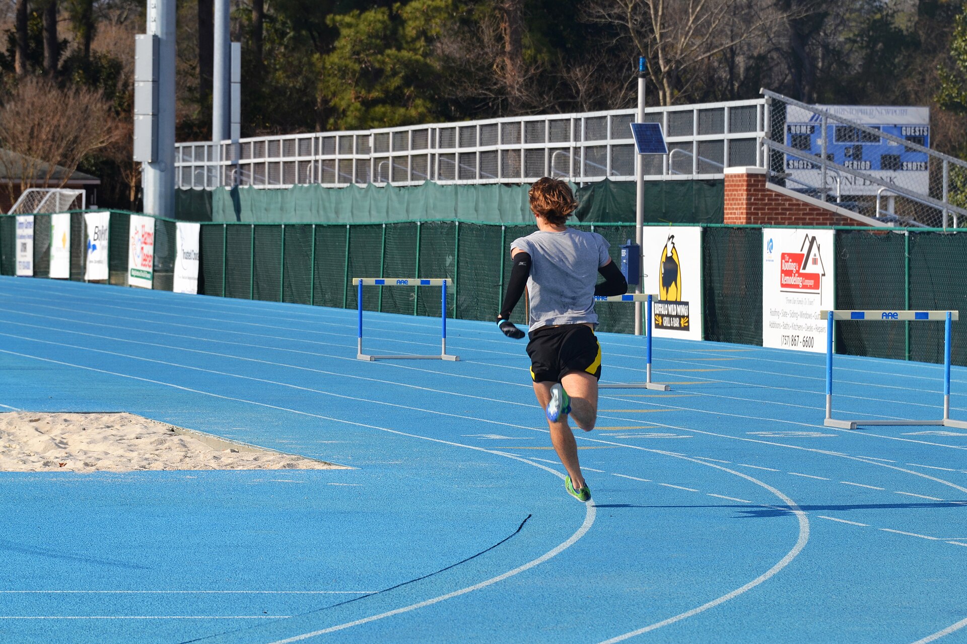 Real runner training alone on an outdoor track
