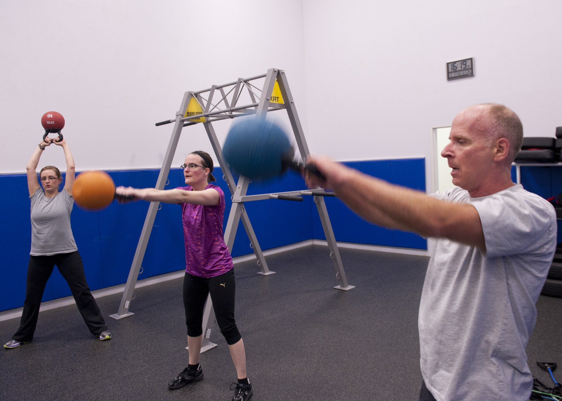Real person doing a kettlebell-style strength exercise